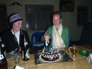 Kirsty watches as Emily_B cuts her birthday cake